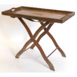 An Indian hardwood rectangular tray table, the galleried top carved with flowers, leaves, etc. and