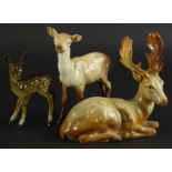 A Beswick recumbent stag, number 954, 18cm wide, a standing doe and a further fawn, unmarked (3).