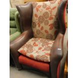 A modern leather wingback armchair, upholstered in floral fabric.
