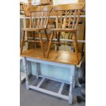 A pair of oak kitchen chairs and a narrow topped side table.