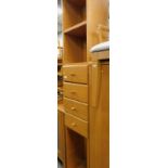A light wood narrow shelving unit, with drawers to centre and a free standing bookcase (2).