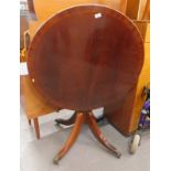 A mahogany tilt top table, on paw feet.