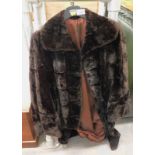 A ladies faux fur coat, three quarter length.