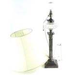 An early 20thC silver plated Corinthian column table lamp, with later shade, cut glass reservoir and