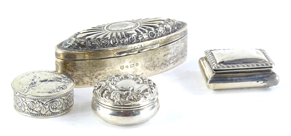 A collection of small silver and white metal boxes, to include a navette shaped box, with hinged