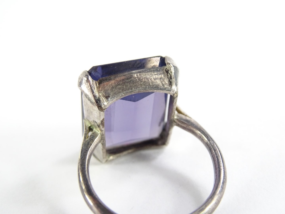 A chunky design dress ring, set with rectangular cut purple coloured paste stone, in a white metal - Image 2 of 2