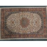 A Persian rug, with a central medallion, in orange, on a floral and leaf cream ground, with
