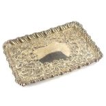 An early 20thC silver tray, of rectangular form, with gadrooned outline and repousse decorated inner