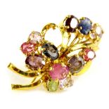 A costume jewellery brooch, set in the form of a floral spray, with multi coloured pink and purple