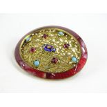 An Eastern buckle brooch, the original oval buckle with red enamel surround (AF), with later