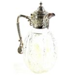 A late Victorian cut glass and silver mounted claret jug, with a faceted body, the mount decorated