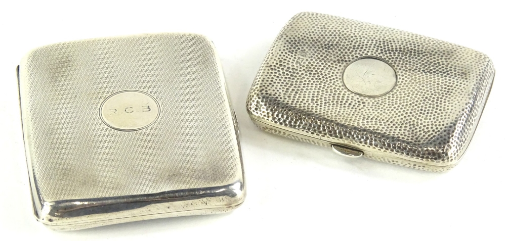 A late Victorian silver cigarette case, with stippled decoration, surrounding a circular vacant