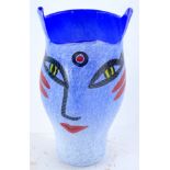 A Kosta Boda Open Minds vase, designed by Ulrika Hydman-Vallien, on a mottled white and blue ground,