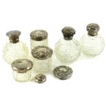 A collection of cut glass and silver mounted scent bottles, to include three globular examples,