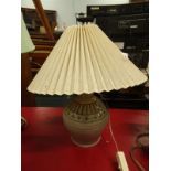 A Studio Pottery table lamp, decorated with geometric devices, on a cream ground, and a pleated
