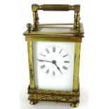 A late 19thC French brass carriage timepiece, the white enamel dial with Roman numerals, the case