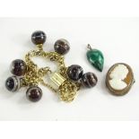 Three items of jewellery, comprising a silver framed cameo brooch, a malachite tear-drop design