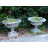 A pair of composition garden urns, each with a leaf cast border, lattice sides and tapering base