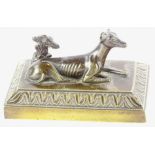 A 19thC bronze model of a reclining hound beside grape vine, on a rectangular base, 13cm wide.