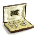 A gentleman's collar tie and cufflinks set, each set with mother of pearl panel, surrounded by white