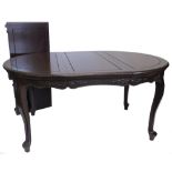An oriental hardwood extending dining table, the rectangular top with a moulded edge and rounded