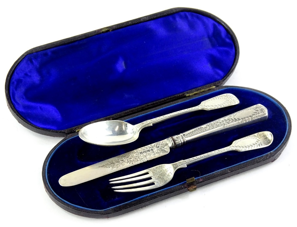 A George V silver christening set, comprising fiddle pattern spoon and fork and a knife, each