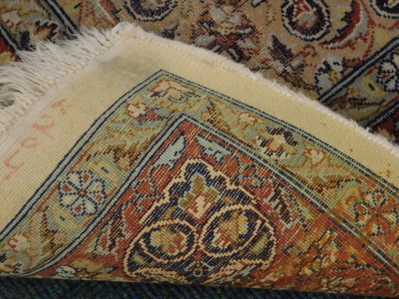 A Persian rug, with a central medallion, in orange, on a floral and leaf cream ground, with - Image 3 of 3