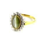 An 18ct gold floral cluster ring, set with opalescent pale green moon type stone to centre, in rub