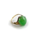 A jade set dress ring, with oval cabochon type cut pale green jade stone, 15mm x 12.2mm x 5.8mm,
