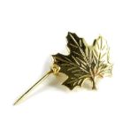 A Canadian maple leaf brooch, in gold plated frame, bearing stamp to back CJ, 2cm wide.