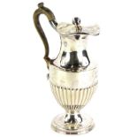 An Edwardian silver part fluted hot water jug, the hinged lid with a spherical knop, the handle of