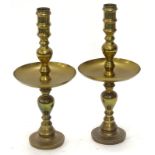 A pair of large Dutch style turned brass candlesticks, each with a dished drip pan, 59cm high.