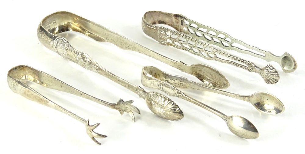 A collection of 19thC and later sugar tongs, to include an example with pierced and engraved sides