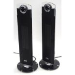 Two Dimplex DXSTG25 upright heaters, with remote controls.