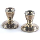 A pair of Elizabeth II silver and dwarf candlesticks, each with reeded borders, Birmingham 1990, 4.