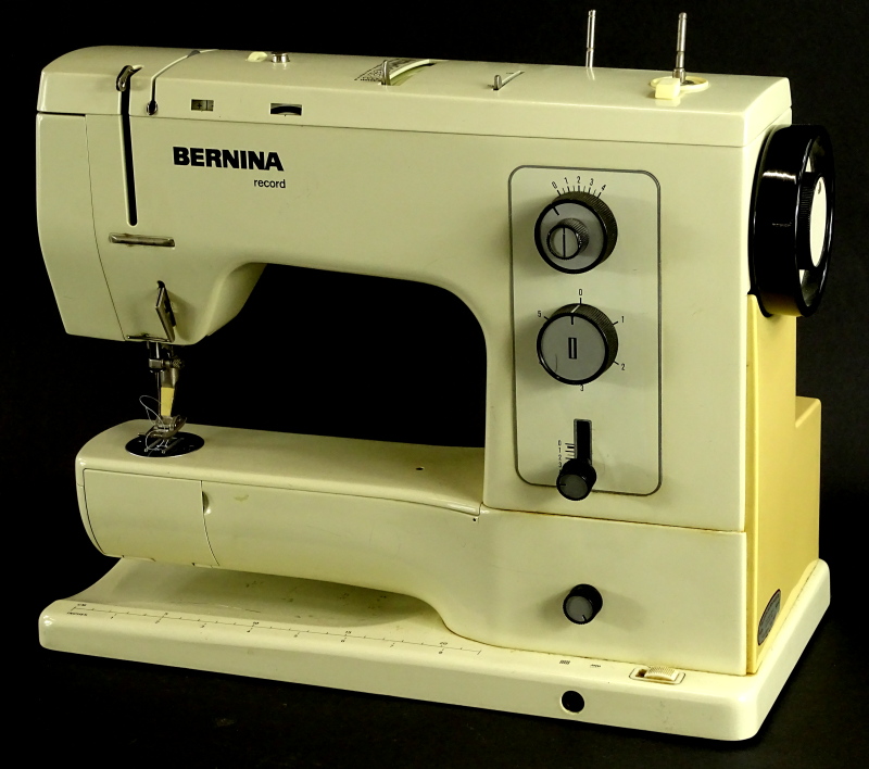 A Bernina sewing machine, in red case.