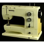 A Bernina sewing machine, in red case.