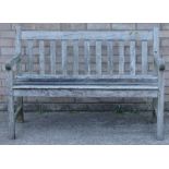 A slatted teak garden bench, 121cm wide.