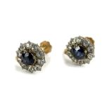 A pair of Victorian style cluster screw on earrings, each set with central pale blue stone,