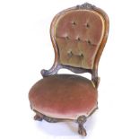 A walnut spoonback nursing chair, the frame carved with scrolls, leaves etc., upholstered in