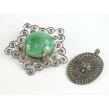 Two items of silver jewellery, comprising a silver star design scroll brooch, with green central