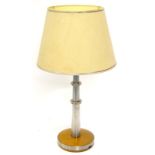 An unusual steel and hardwood table lamp, inset with red LED type lights, on a circular base,