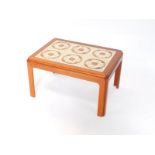 A G-Plan teak and tile inset occasional table, set with six floral tiles, raised on square legs,