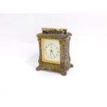 A Waterbury Clock Company late 19thC brass cased alarm carriage clock, 11cm high, 8cm wide.