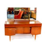A Nathan teak dressing table, with a triptych mirror, over one long and two short drawers, above a