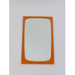 A Danish teak wall mirror, inset bevelled glass, 69.5cm high, 34cm wide.