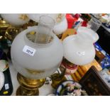 A brass oil lamp, with chimney and frosted and etched glass shade, 55cm high., together with a