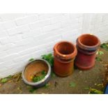 A pair of terracotta chimney pots, together with a blue glazed plant pot. (3)