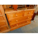 A pine chest of two short over two long drawers, raised on a plinth base, 75cm high, 102cm wide,