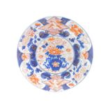 A Japanese Genroku Period imari charger, decorated centrally with a vase of flowers within a